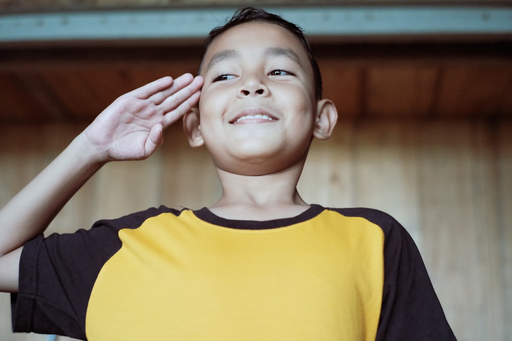 boy in blue and yellow crew neck shirt