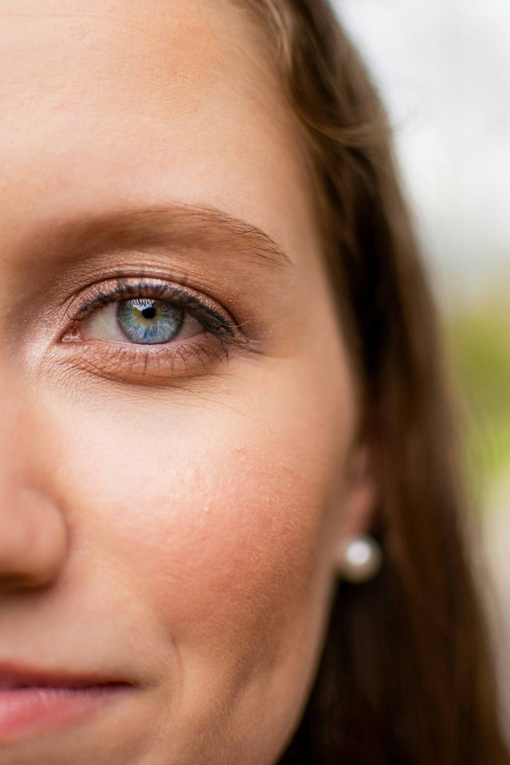 woman with blue eyes and silver nose piercing