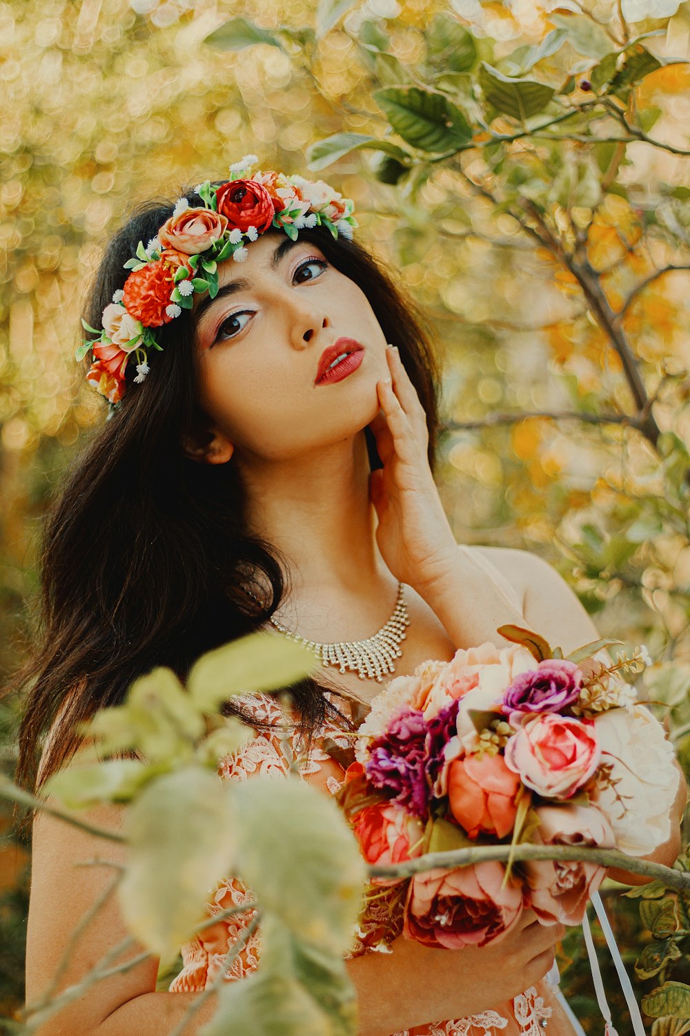 woman in white shirt with red and white floral headdress