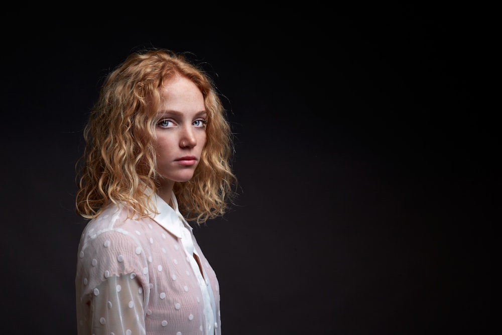 woman in white and black polka dot button up shirt