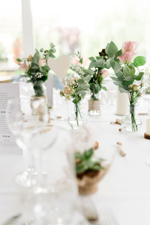 A festive table setup with a muted pastel tablecloth, elegant napkins, and seasonal floral arrangements for a special occasion.