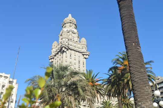 white concrete building under blue sky during daytime in Plaza Independencia Uruguay