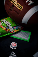 Close-up of colorful football patches arranged on a wooden table.
