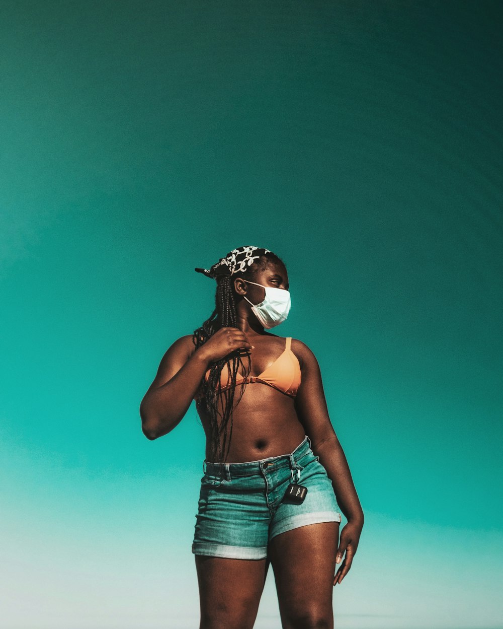 woman in blue denim daisy dukes and white mask