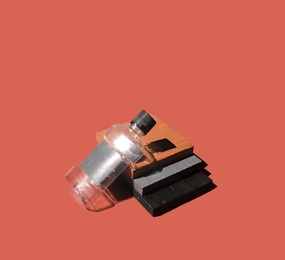 A stack of transparent sample collection bottles with secure lids.