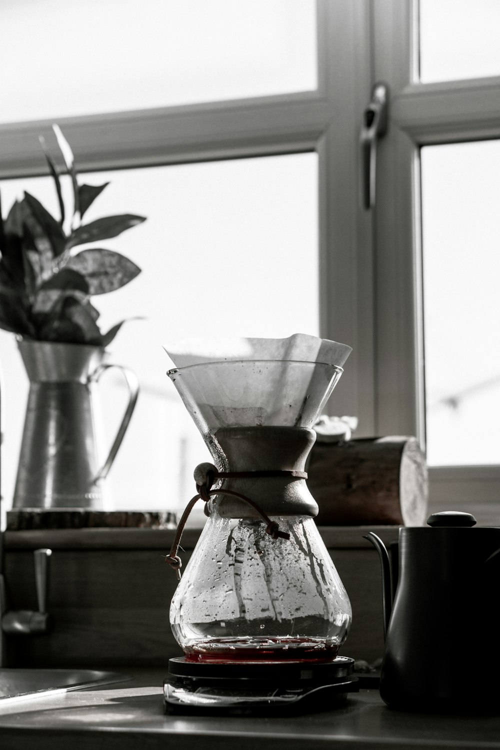 clear glass pitcher on brown wooden table