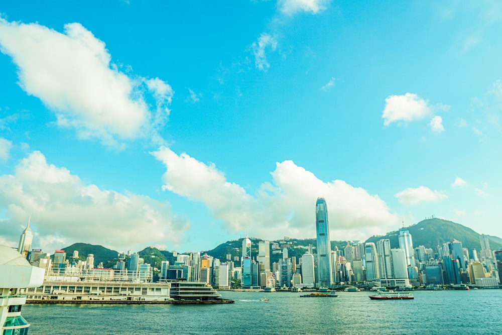 city buildings near body of water under blue sky during daytime