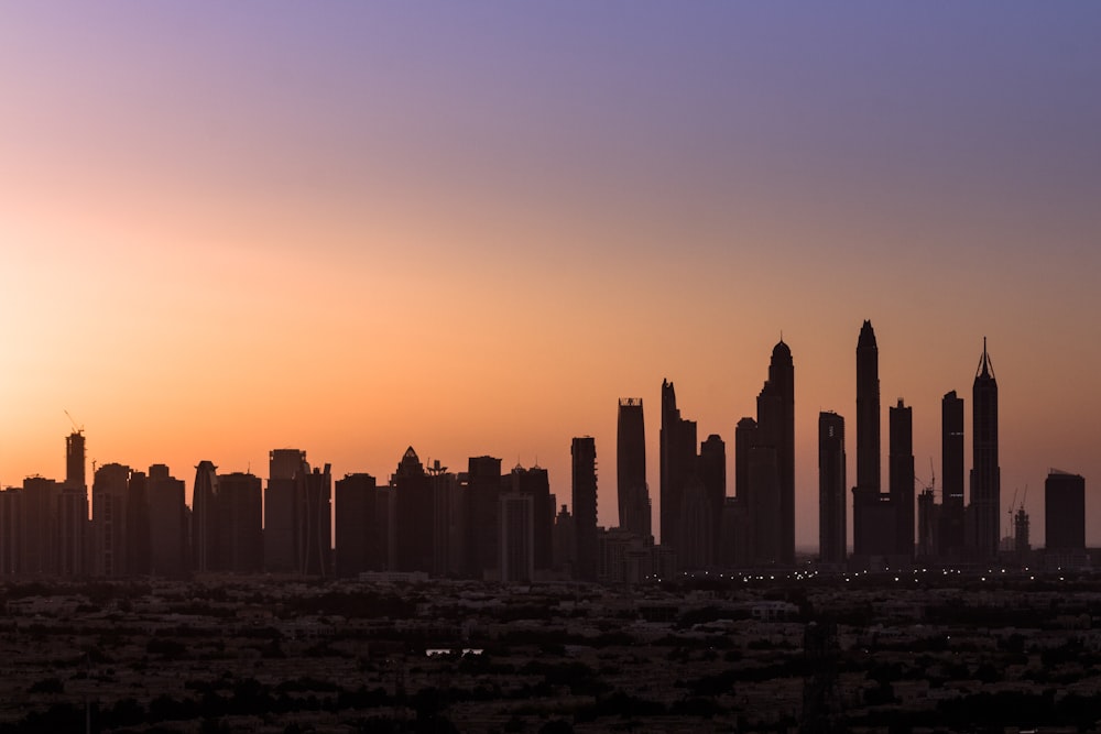 silhouette of city buildings during sunset