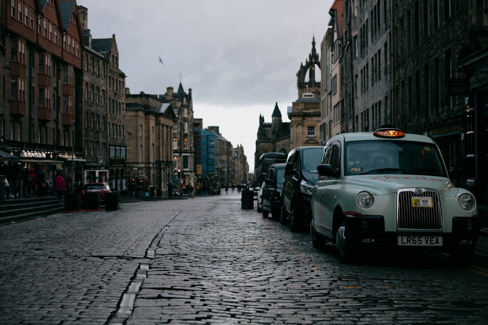 white car on road near buildings during daytime