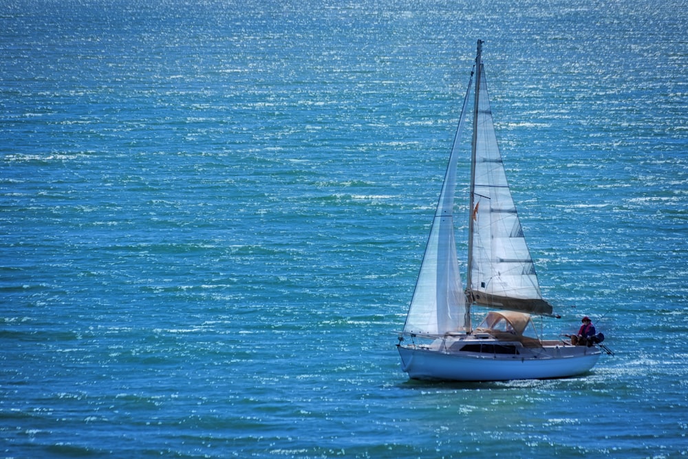 white sailboat on blue sea during daytime