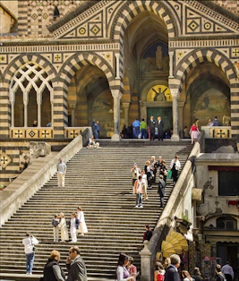 people walking on brown concrete building