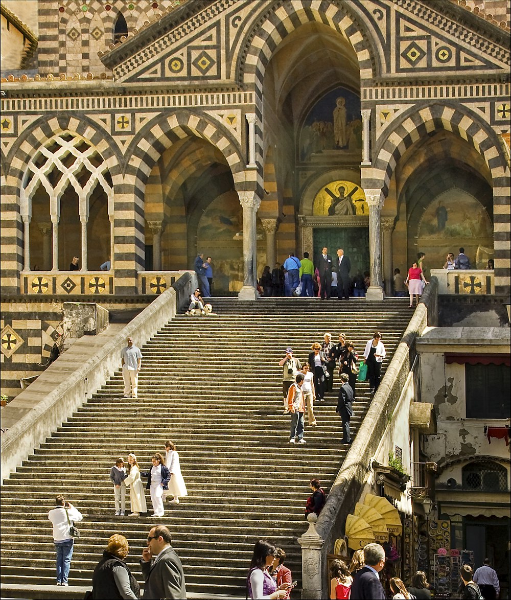 people walking on brown concrete building