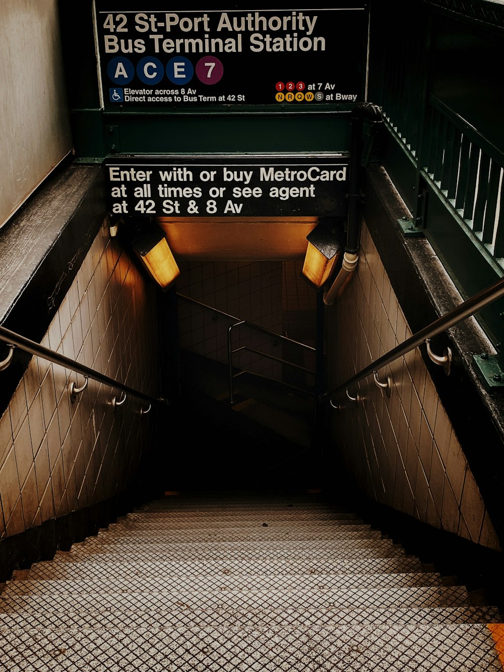 black and white staircase with green and yellow wooden signage