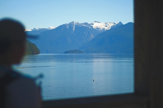 body of water near mountain during daytime in Pitt Lake Canada