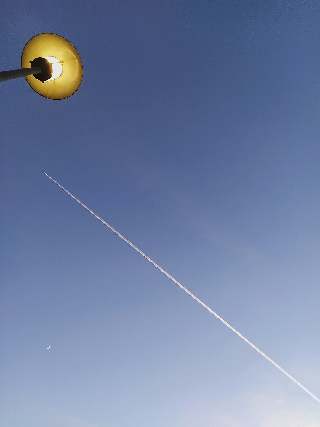 yellow light bulb under blue sky during daytime