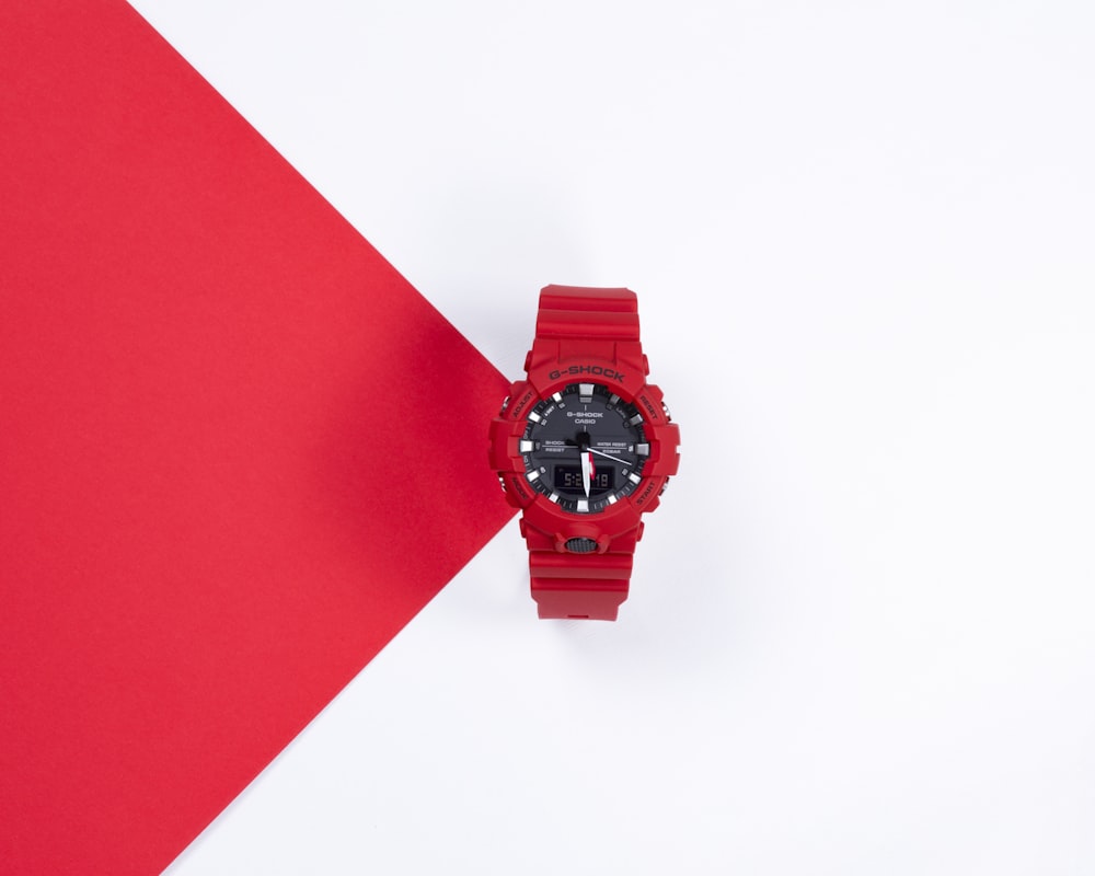 red round analog watch with black strap