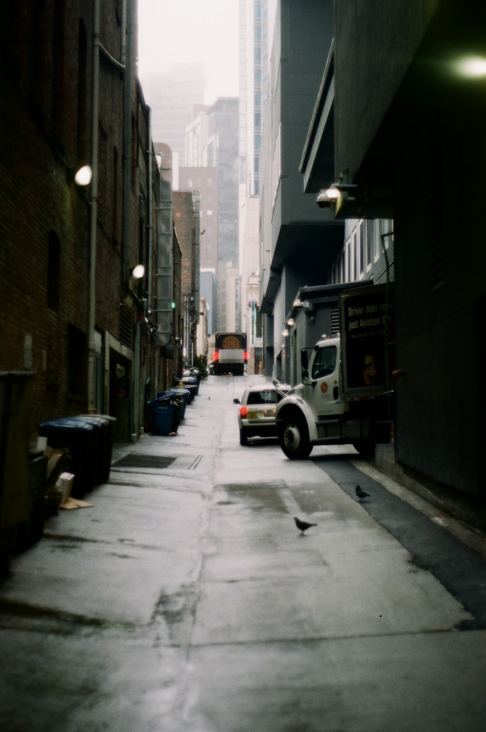 white suv parked beside brown concrete building during daytime