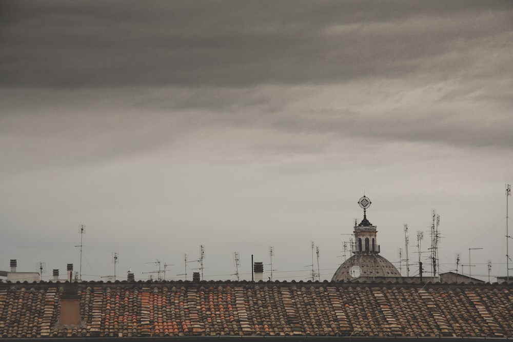 brown and black concrete building under white clouds during daytime