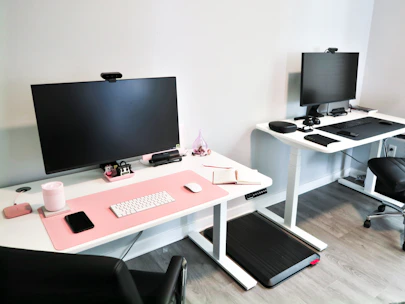 A spacious office desk setup with dual monitors and ergonomic accessories.