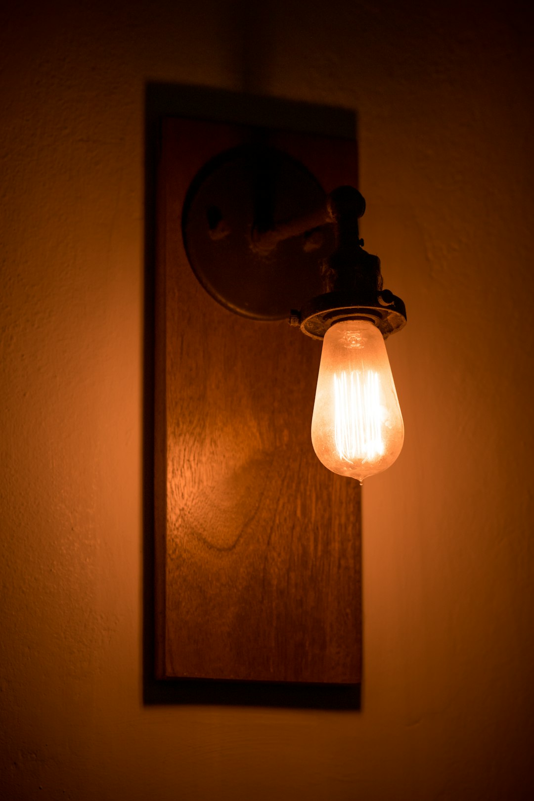 brown pendant lamp turned on in room