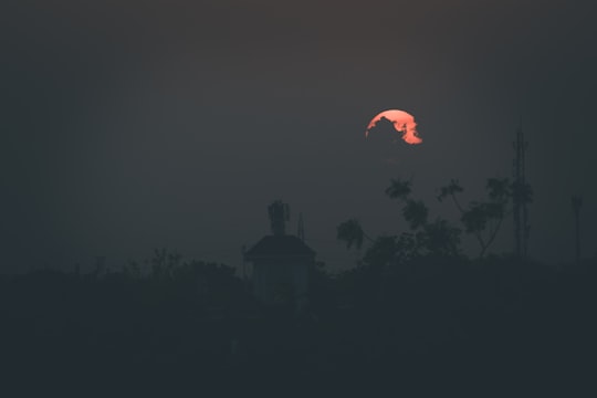 silhouette of building under red sky during night time in Gandhinagar India