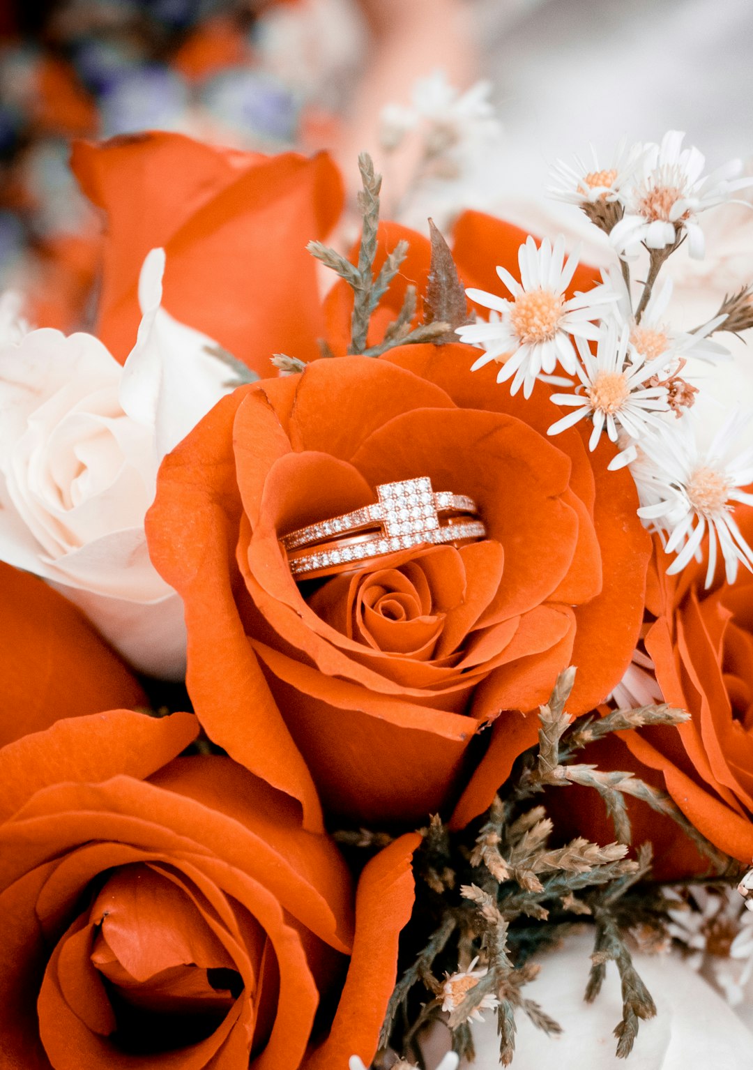 silver ring on orange flower