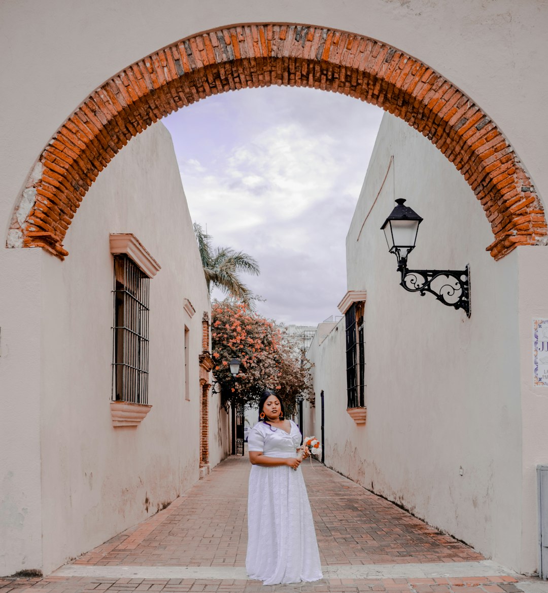 woman in white wedding dress walking on hallway
