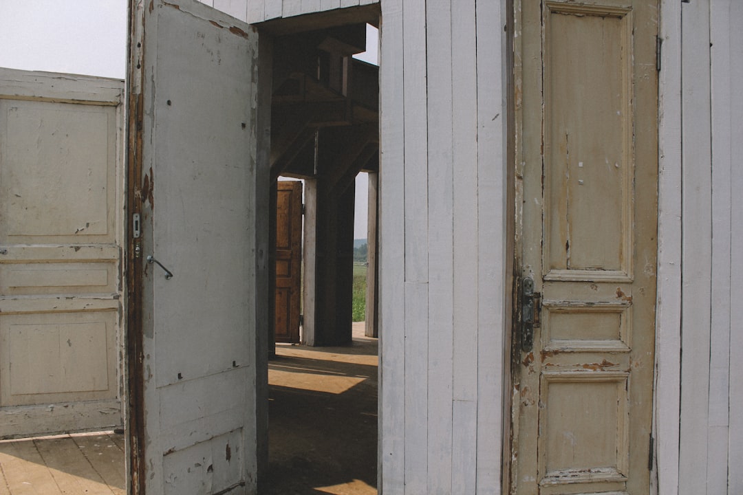 white wooden door near brown wooden door