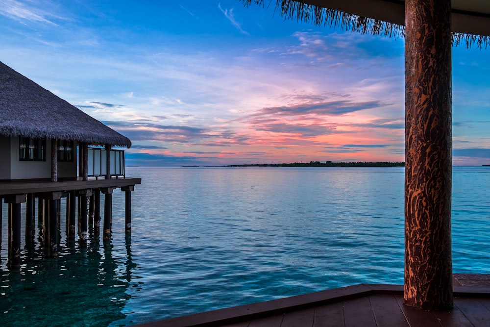 brown wooden dock on blue sea under blue sky during daytime