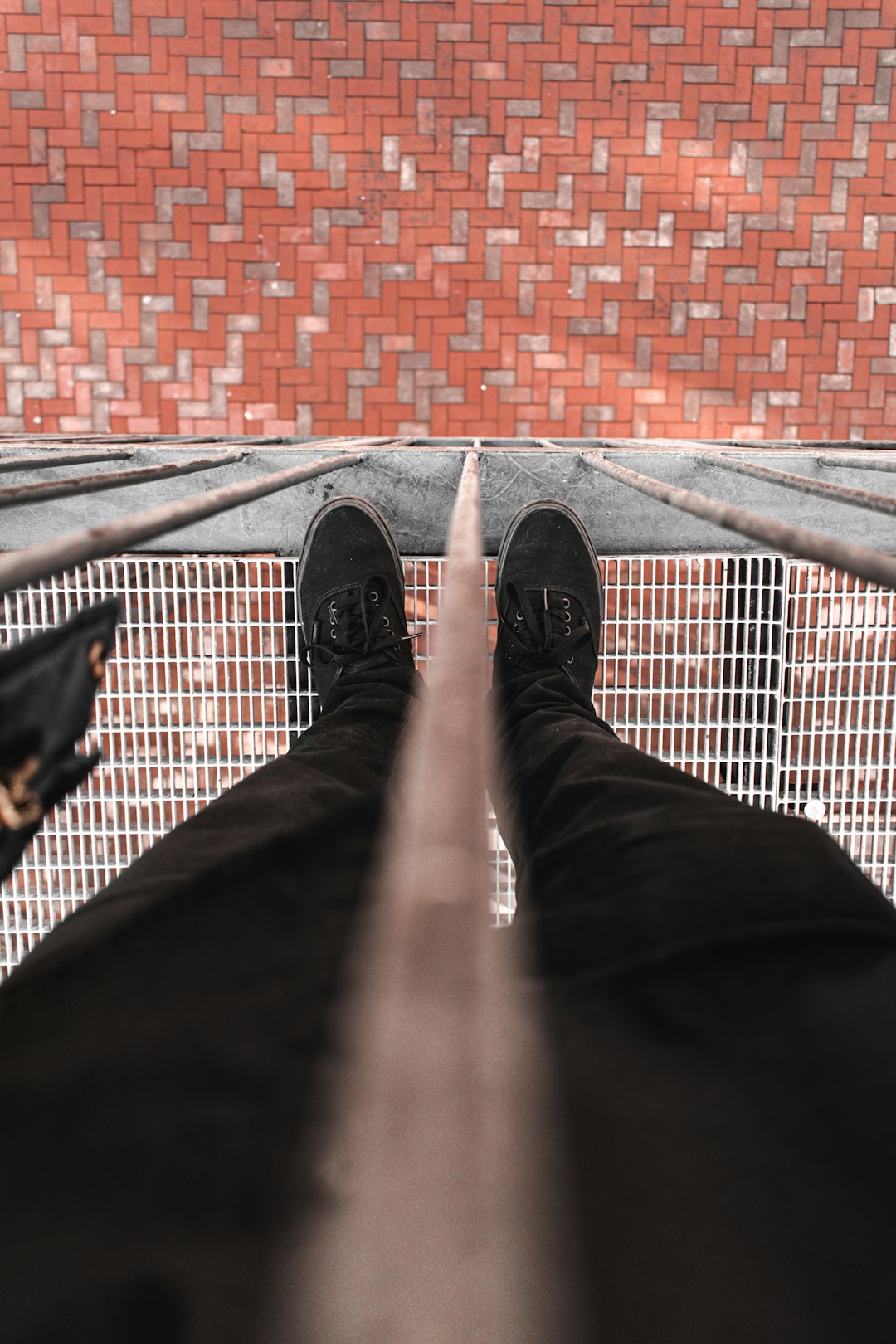 person in black pants and black sneakers