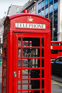 red telephone booth during daytime