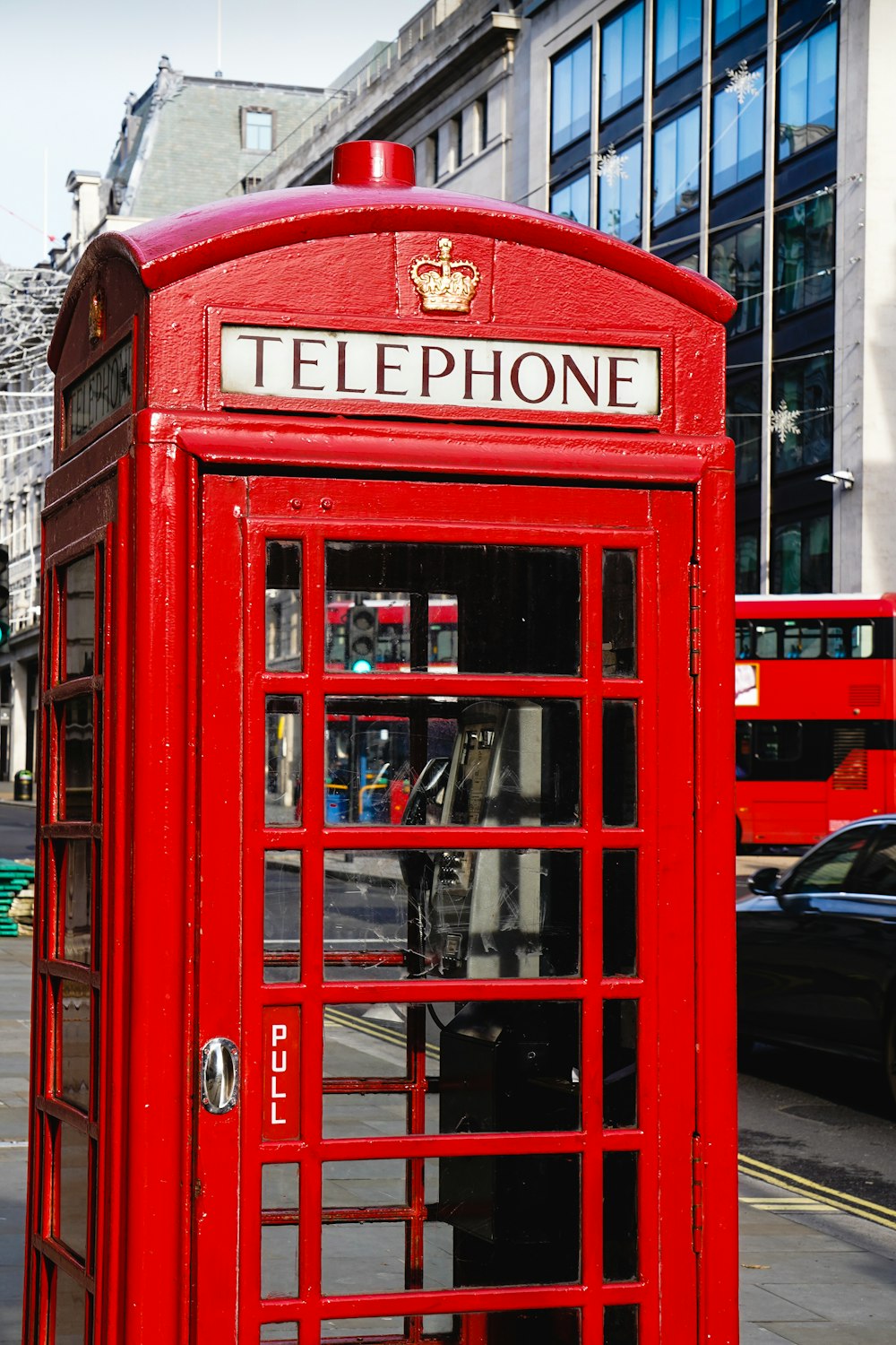 red telephone booth during daytime
