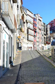 people walking on sidewalk between buildings during daytime