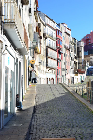 people walking on sidewalk between buildings during daytime