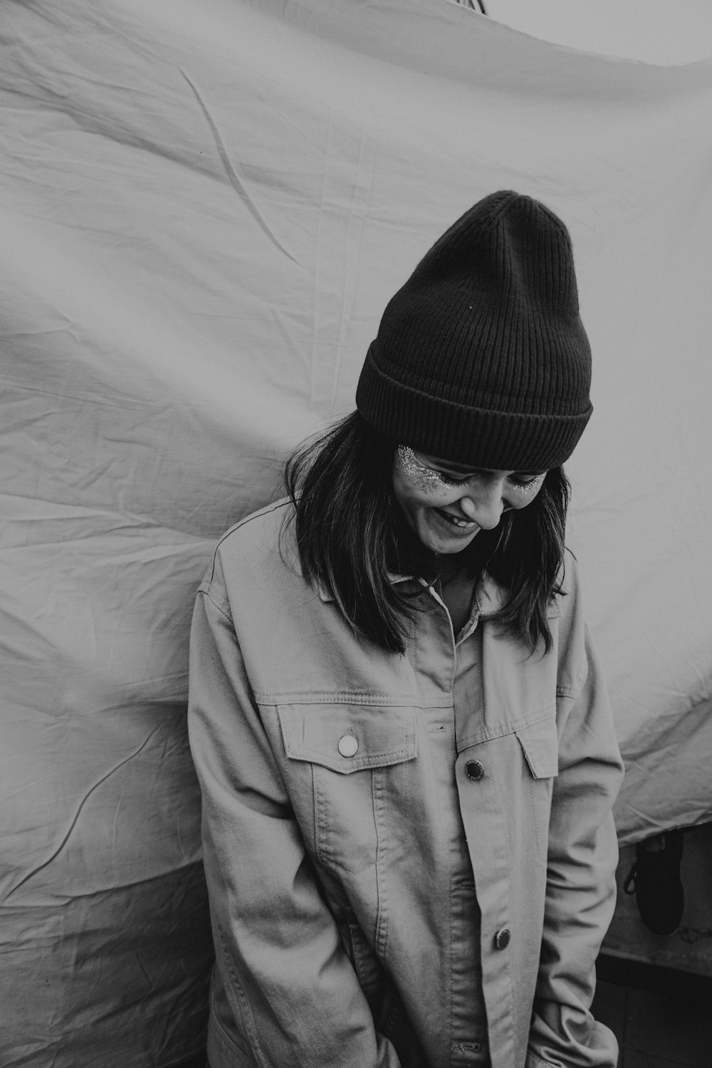 woman in black knit cap and gray coat