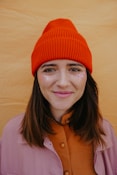 woman in orange knit cap smiling