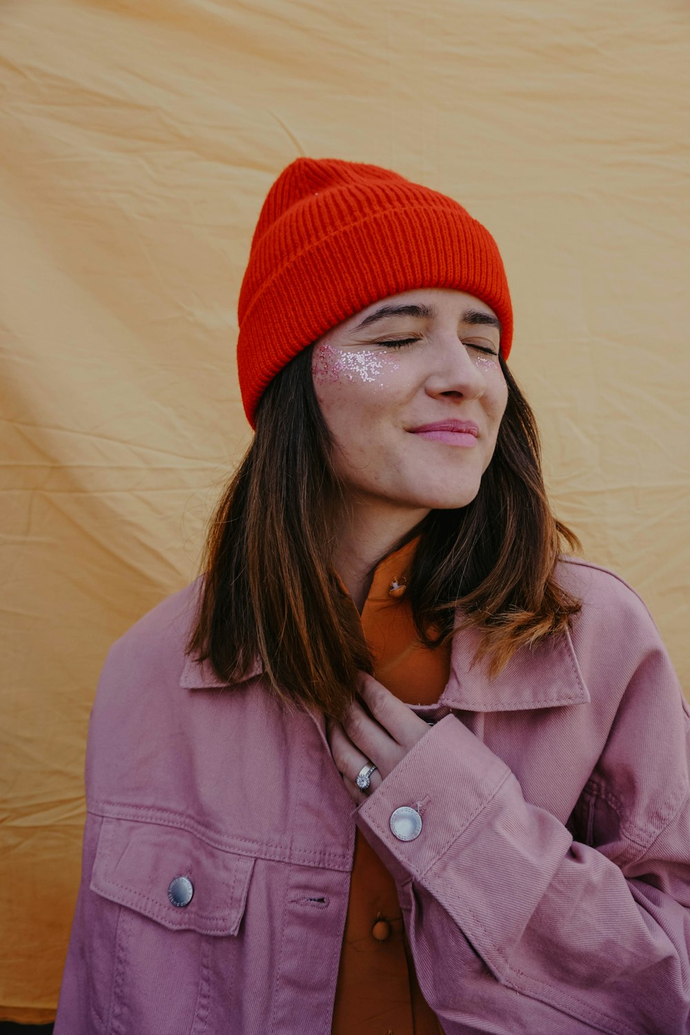 woman in red knit cap and purple button up shirt