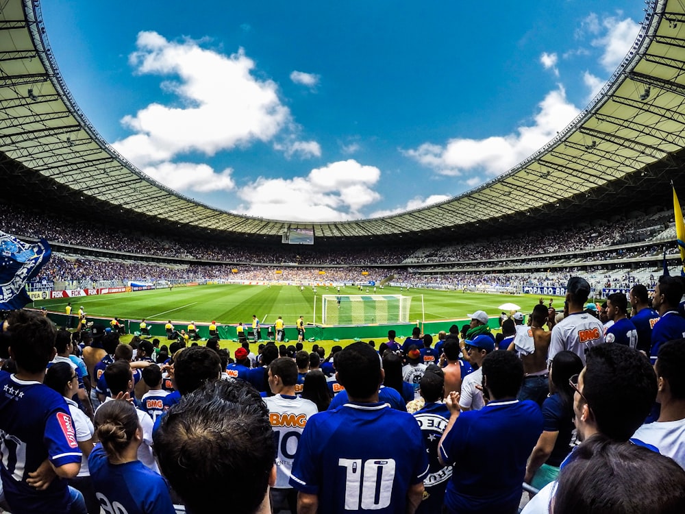 people watching football game during daytime