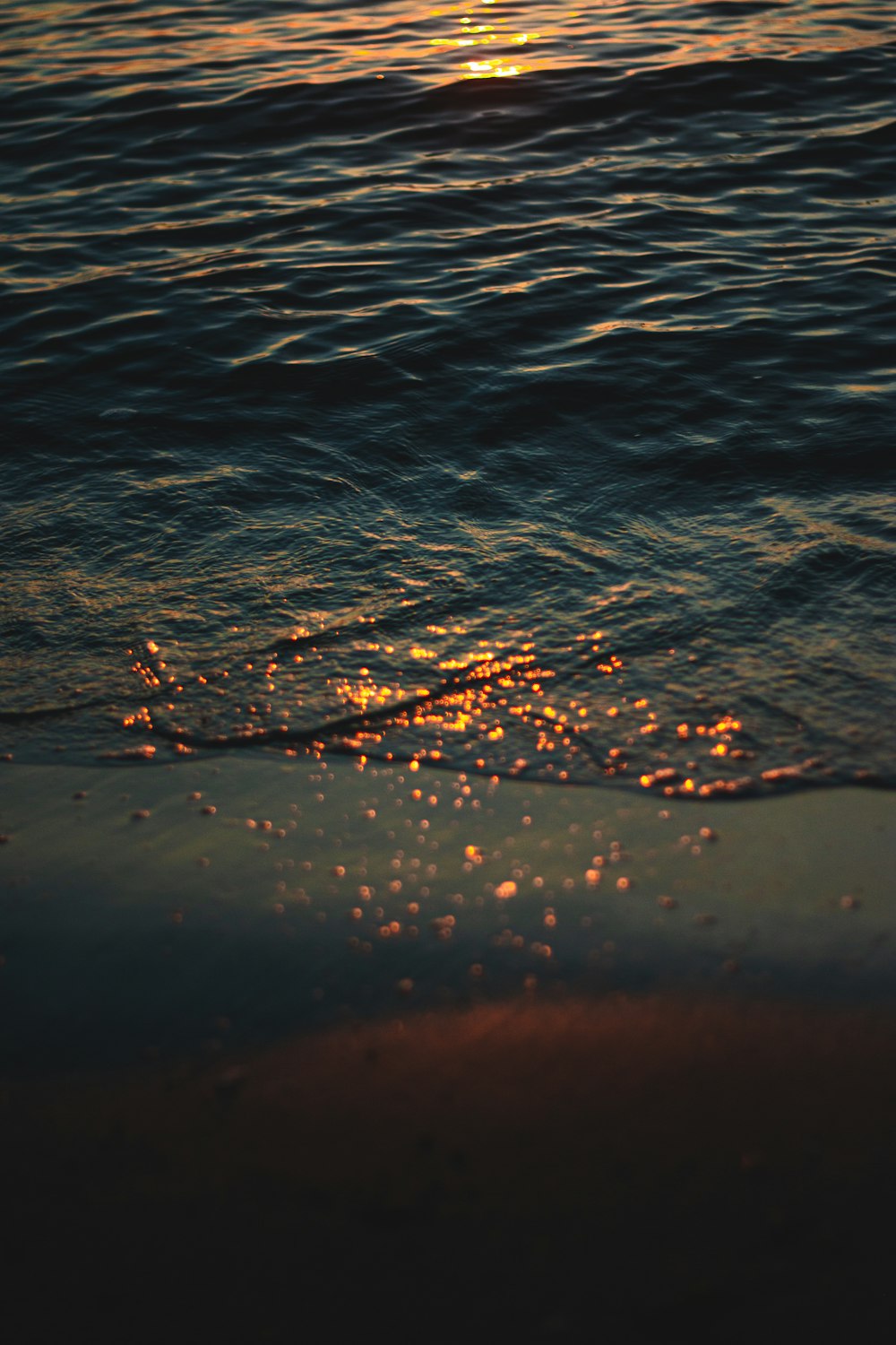 water droplets on body of water during daytime