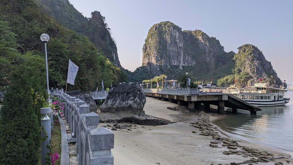 a boat docked at a pier on a beach