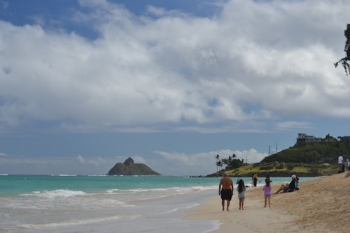 A joyful family exploring a sunny beach in Mauritius, with turquoise waters and palm trees.