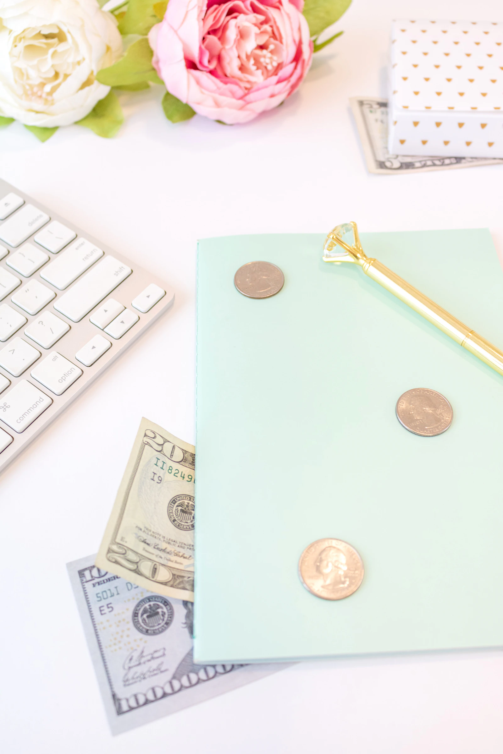 Notes, a pen and cash on a desk.