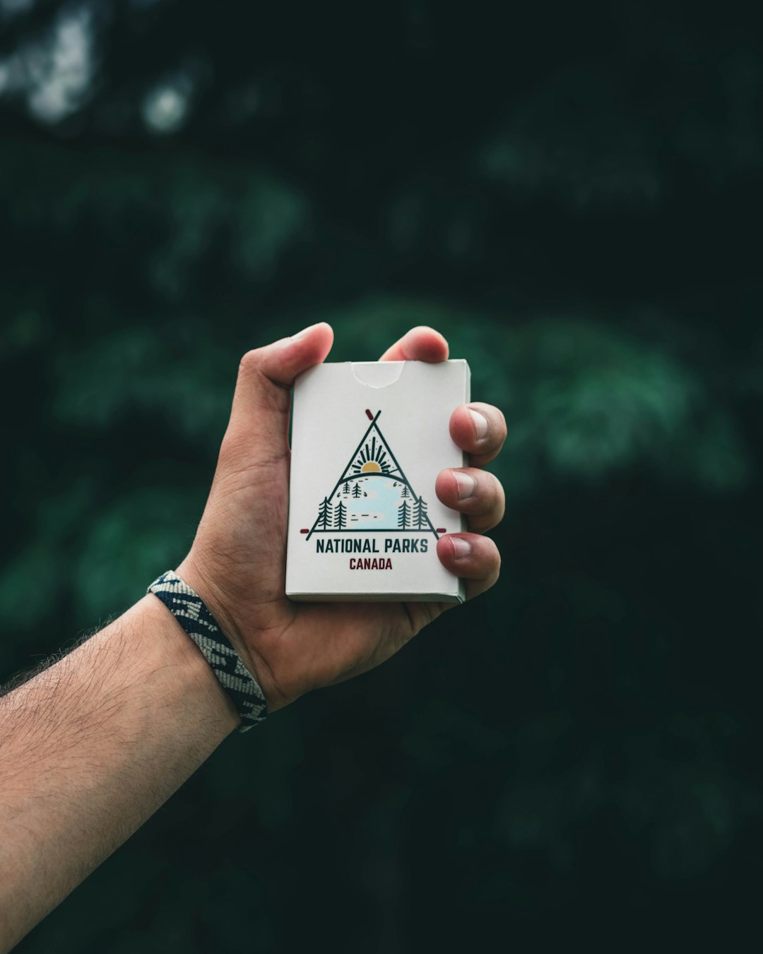 person holding marlboro gold flip top cigarette box