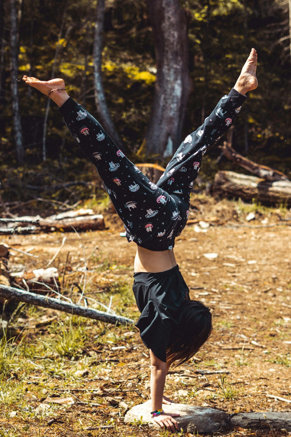 person in black and white star print pants and black boots