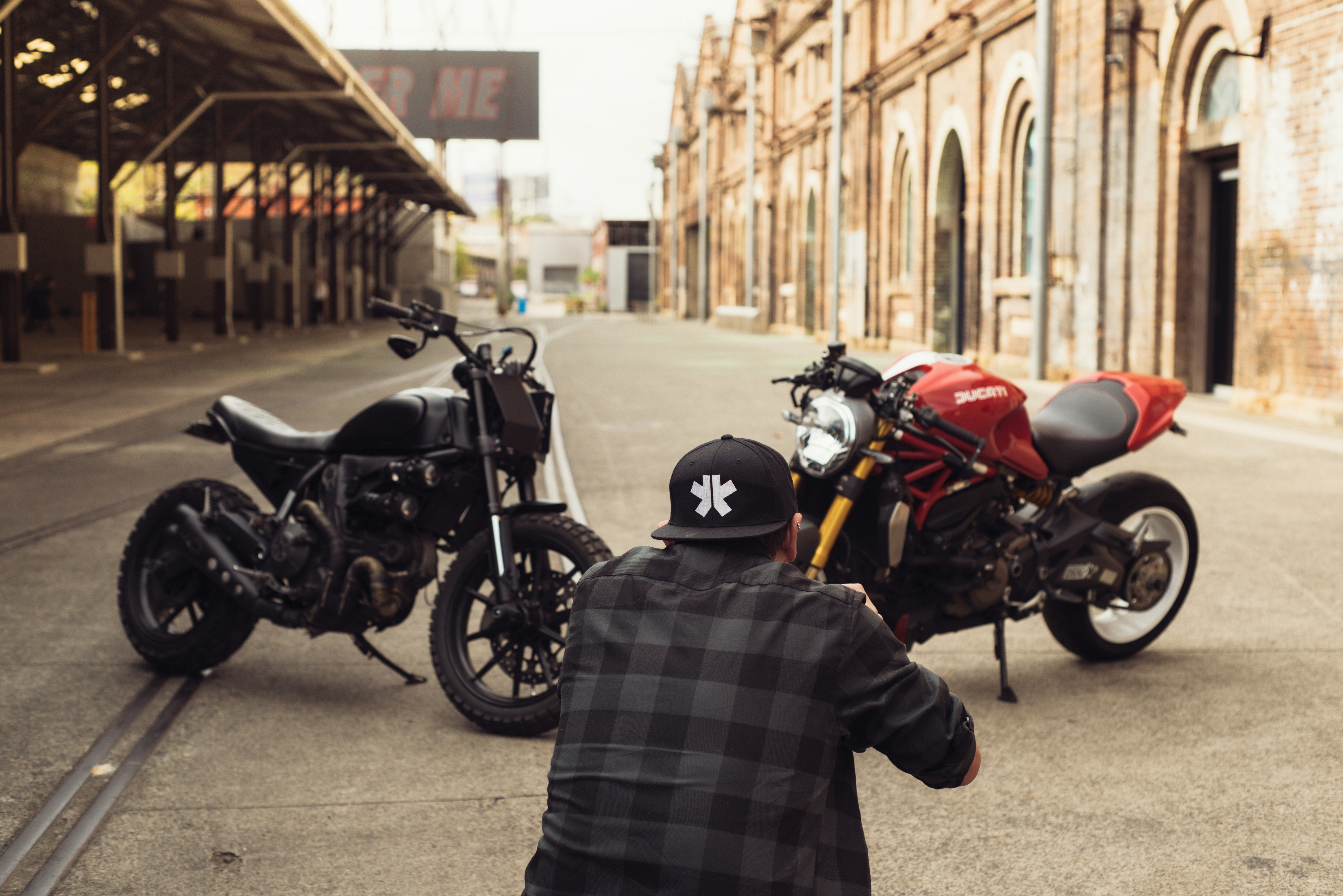 two motorcycles parked next to each other on a street