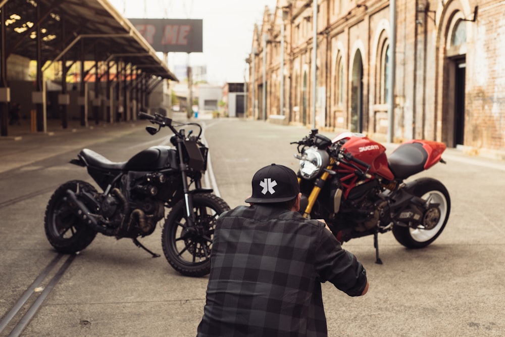 two motorcycles parked next to each other on a street