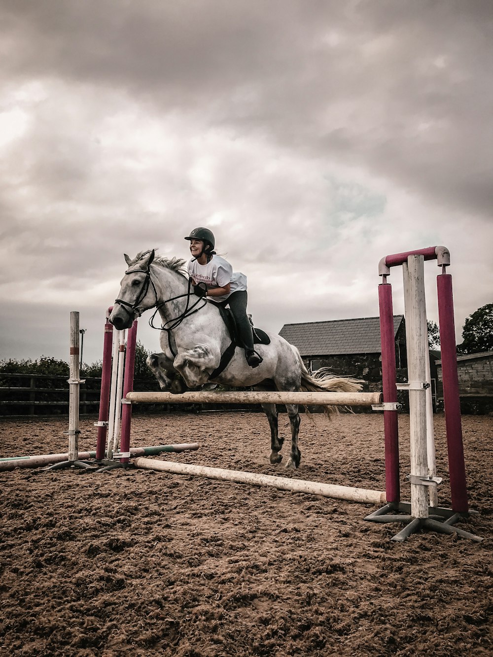 man riding horse on brown field under white clouds during daytime