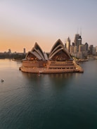 brown boat on water near city buildings during daytime