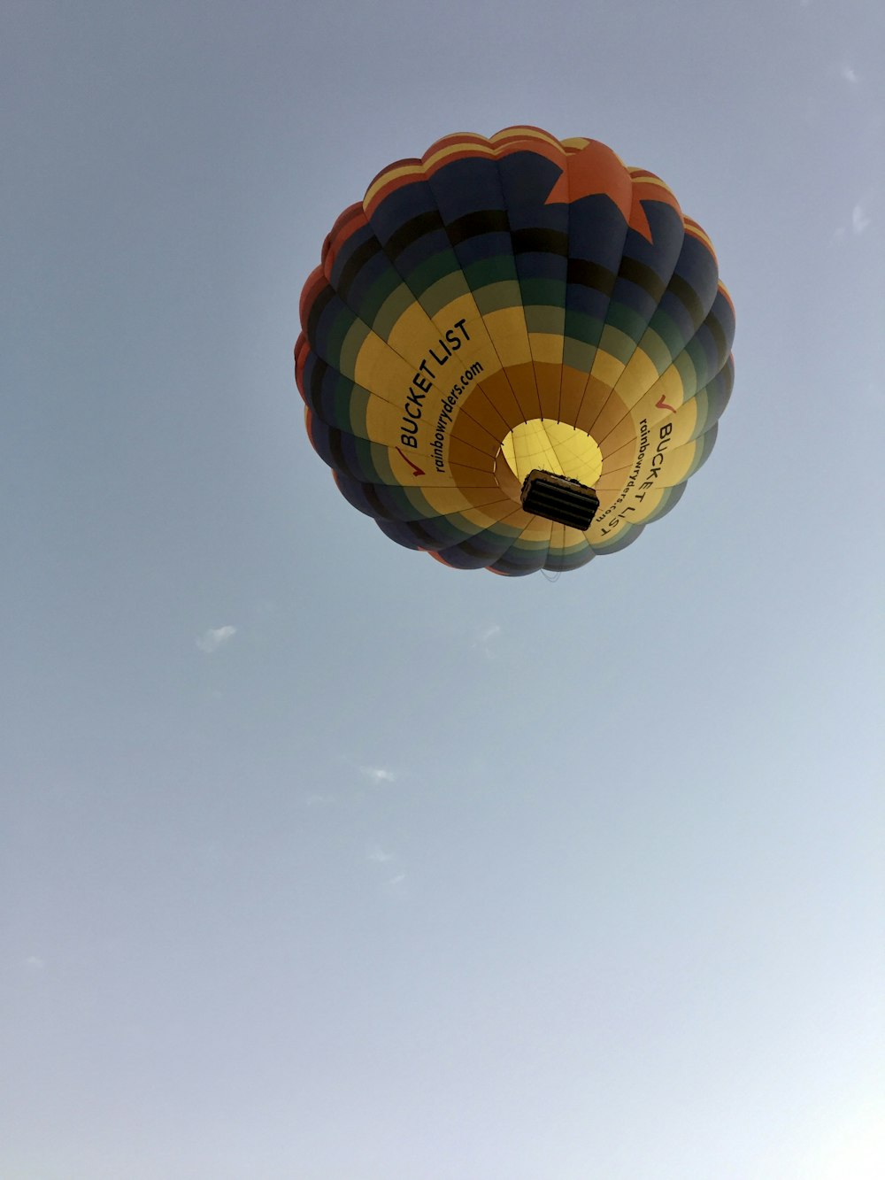 blue red and yellow hot air balloon in mid air