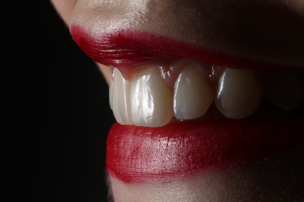 person with red lipstick and white pearl earrings